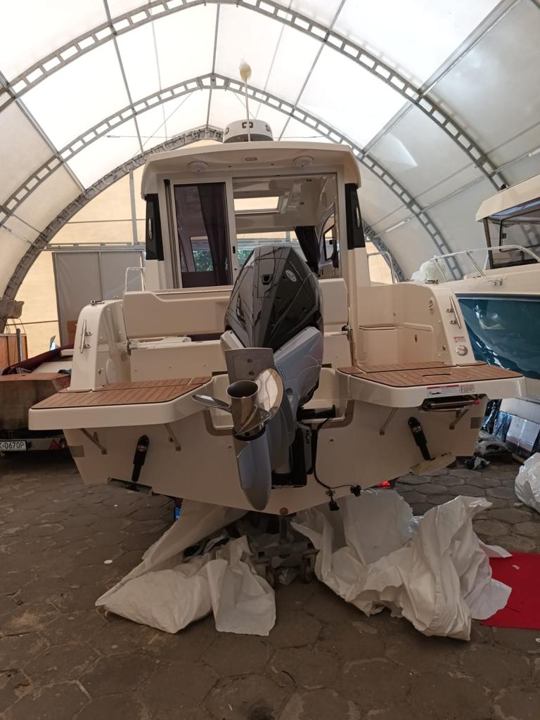 Outboard motor on a pilothouse boat. Marine engine mounting and service in a Polish boatyard.