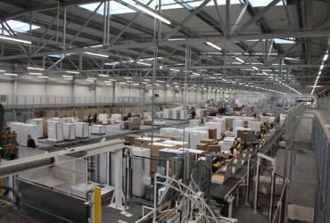 Packaging line. The manufactured goods are packed into the carboard box.