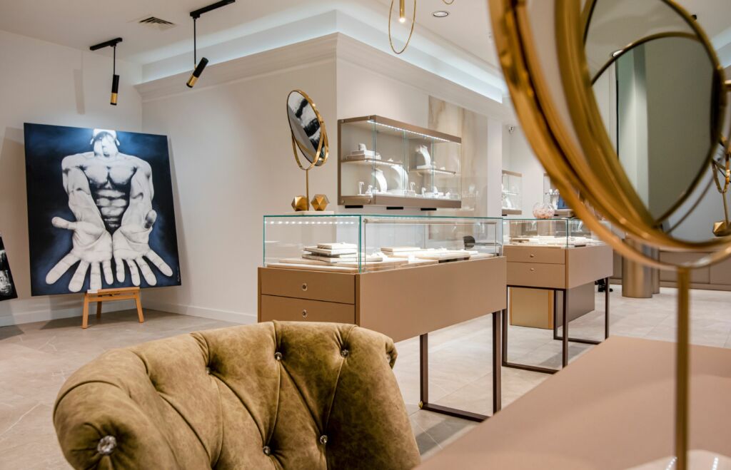 The display tables with drawers and a glass dome, and the hanging cabinets with shelves for displays