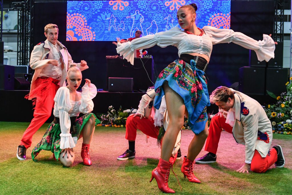 Młodzi tancerze w folkowych strojach tańczą podczas wydarzenia Polska Noc na MaBru