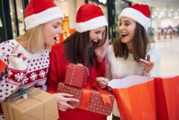 Three young women enjoy Christmas shopping