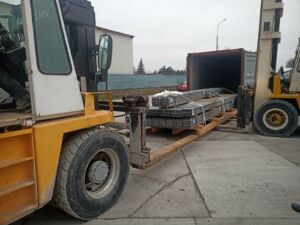 Unloading of steel profiles from a container