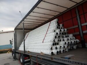 Unloading of rolls from a container