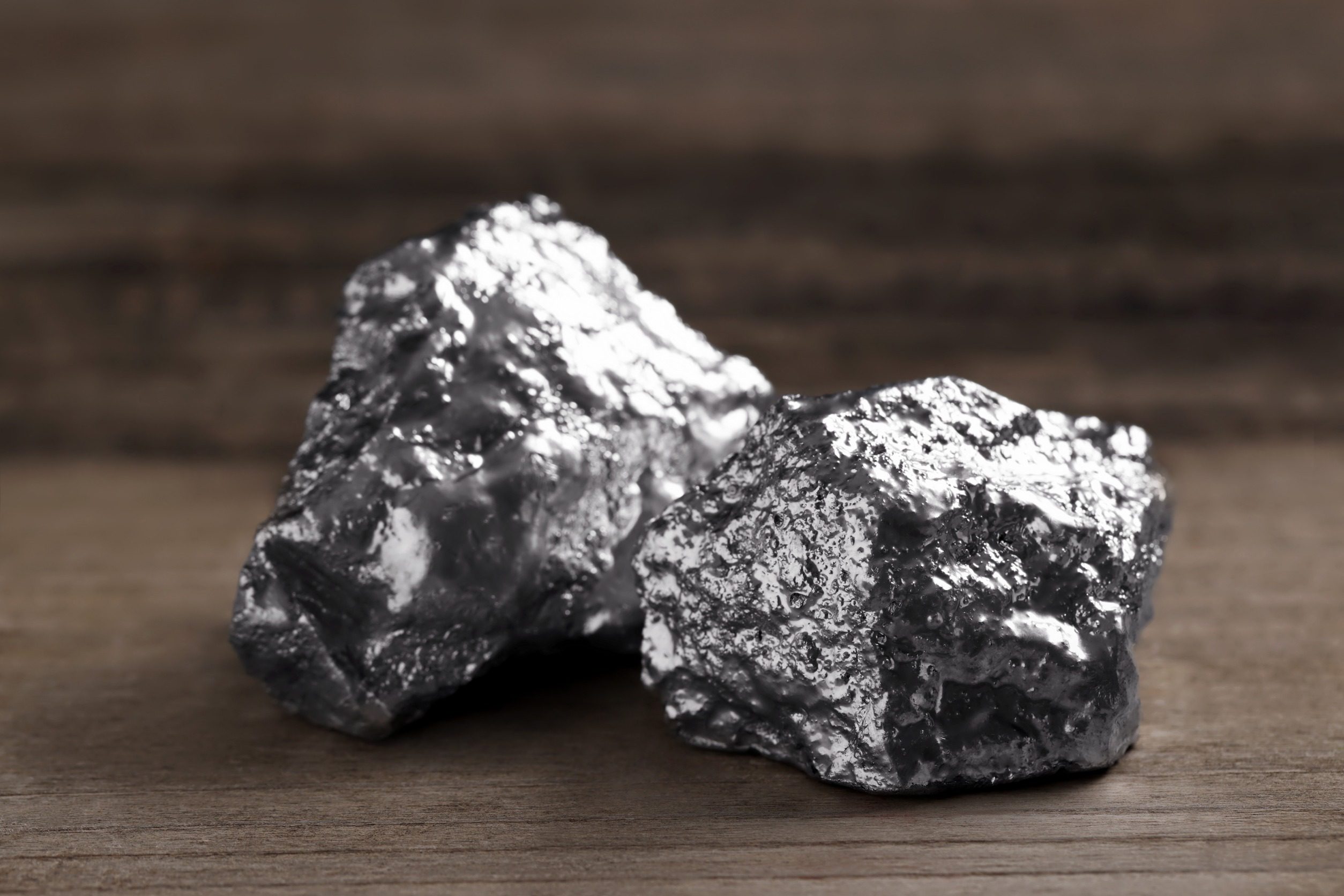 Two silver nuggets on wooden table