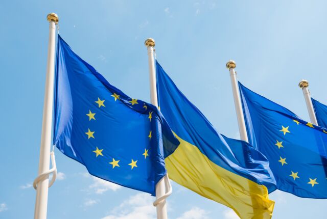 Flagi UE i Ukrainy powiewają na tle błękitnego nieba