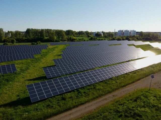 New photovoltaic power plant, sun reflected in solar panels