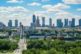 Swietokrzyski bridge and skyscrapers in city center, Warsaw aerial landscape under blue sky