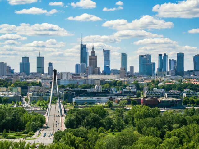 Swietokrzyski bridge and skyscrapers in city center, Warsaw aerial landscape under blue sky