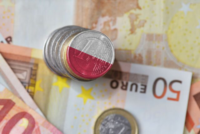 euro coin with national flag of poland on the euro money banknotes background.