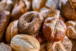 Assorted bakery products including loaves of bread and rolls