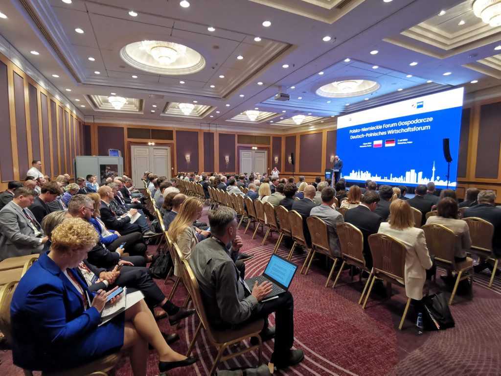 Conference participants listen to the speech