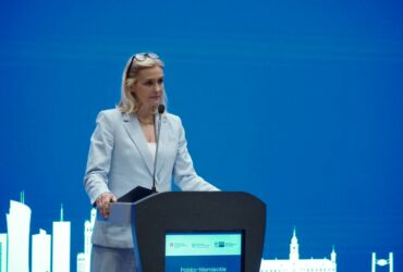 A woman speaking from the stage