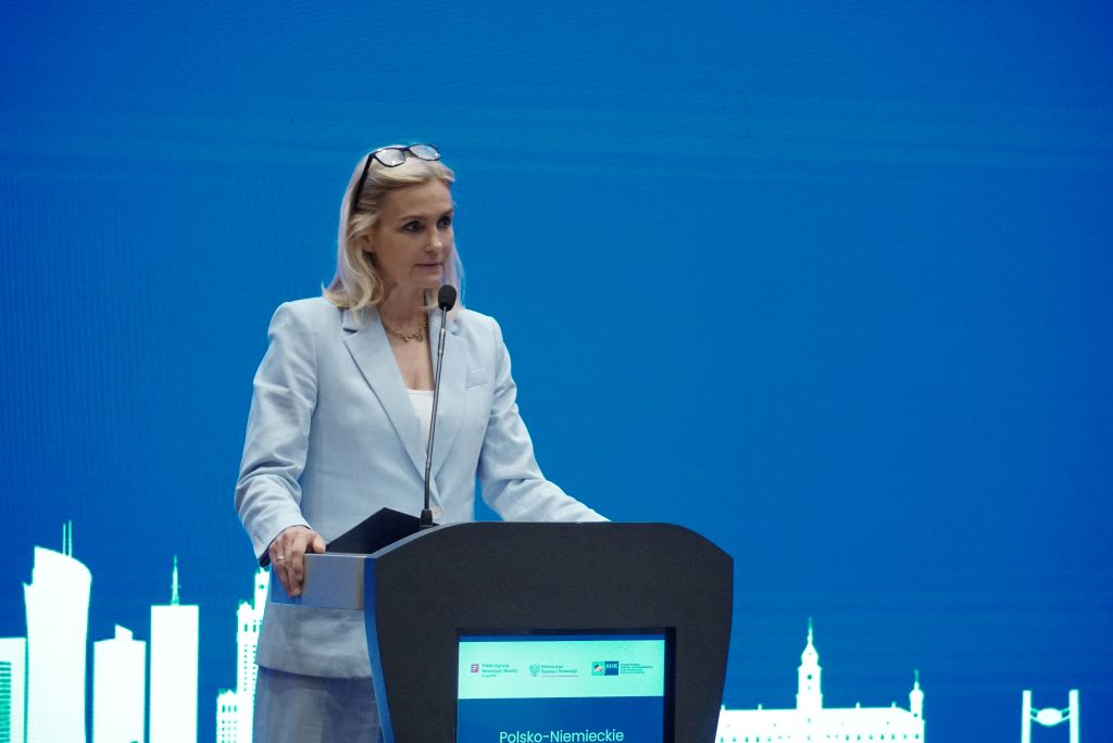 A woman speaking from the stage