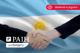 uścisk dłoni biznesmenów na tle falgi Argentyny