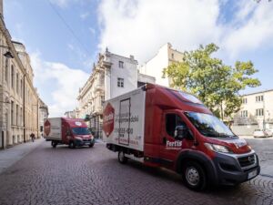 Fortis Moving trucks operating in a historic European city center, showcasing the company’s professional 