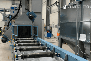 Pass-through blasting machine TZNP in the shot blasting room of an industrial company.