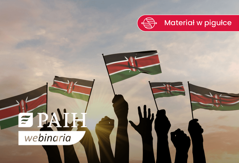 dłonie trzymające małe chorągiewki-flagi Kenii