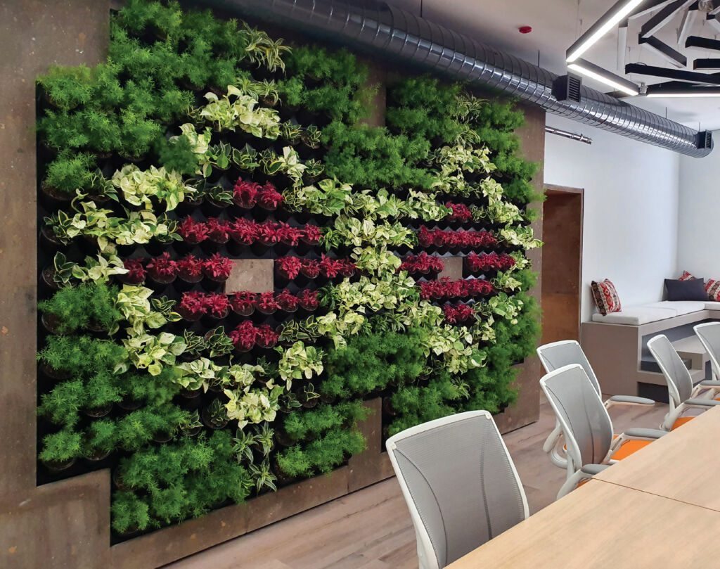 A permanent green wall with a floral arrangement.